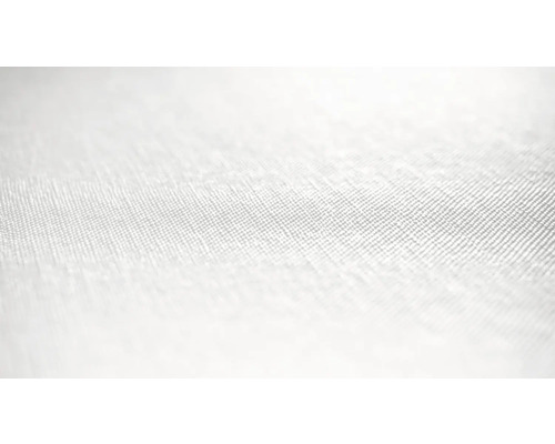 Närbild av ett ljust textilmaterial med fin vävstruktur