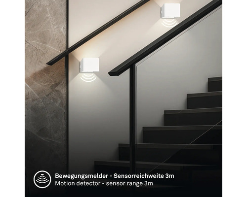 Två vita vägglampor med rörelsedetektor i en trappa
