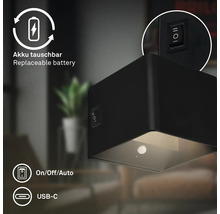 Svart LED-vägglampa med utbytbart batteri och USB-C-port