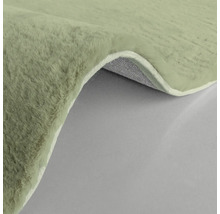 Detaljvy av en ljusgrön matta med lugg