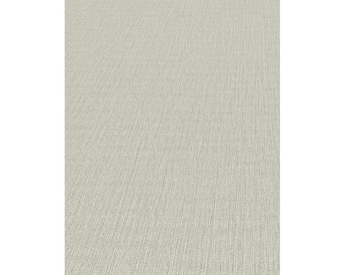 Detaljvy av en beige strukturtapet.