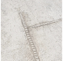 Detaljvy av en tapet med jeanssömmar