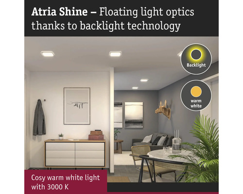 Atria Shine taklampor med bakgrundsbelysning i vardagsrum.