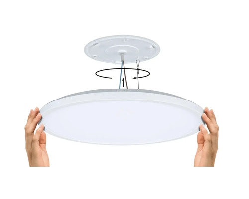 Installationen av en platt LED-taklampa demonstreras med hjälp av händer.
