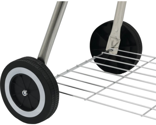 Detaljvy av hjul och förvaringsgaller på en grillvagn.