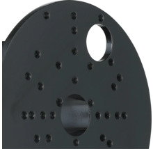 Svart metallskiva med skruvhål och öppningar