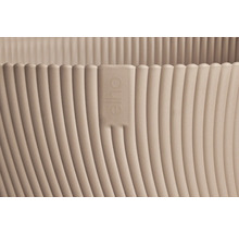 Detalj av en blomkruka med en vertikal ribbad textur och Elho-logotypen