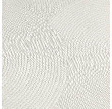 Närbild av en vit strukturtapet med cirkelformat mönster