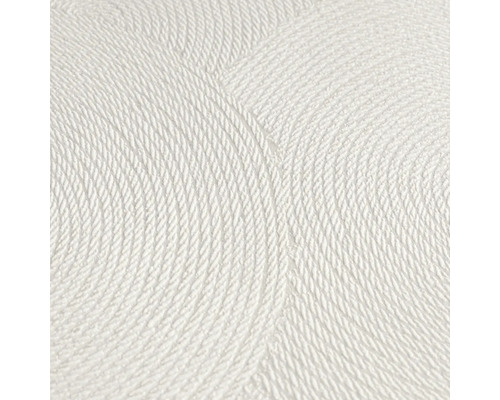 Närbild av en vit strukturtapet med cirkelformat mönster