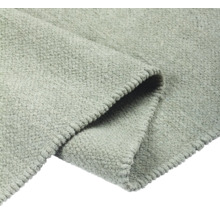 Detaljvy av en grå matta med textur