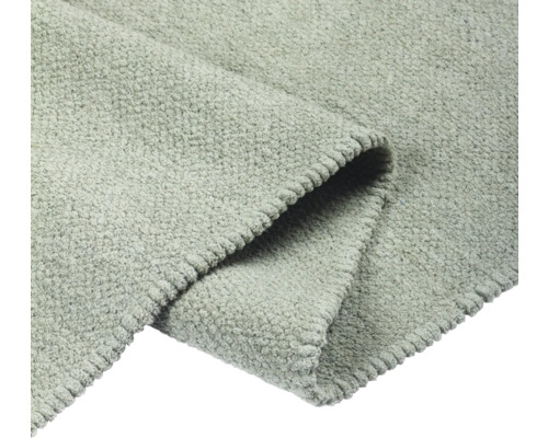 Detaljvy av en grå matta med textur