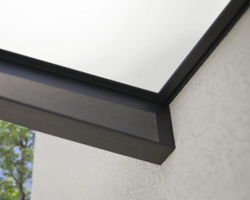 Detaljvy av ett terrassöverdrag med aluminiumprofiler och en glasskiva på en strukturerad vägg.