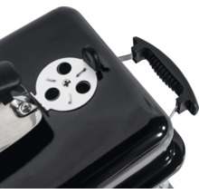 Detaljvy av en kolgrill med ventilationsspjäll och handtag