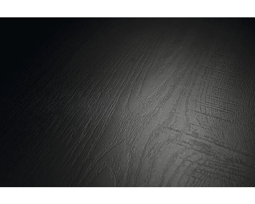 Närbild av en yta med mörk trästruktur och kännbar ådring.