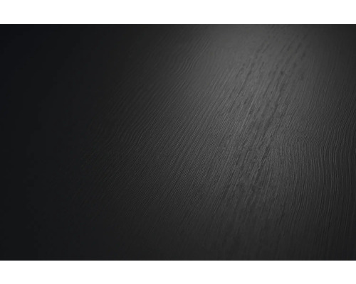 Närbild av en mörk yta med fin trästruktur.