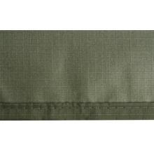 Detaljvy av olivgrönt ripstop-tyg med rutmönster och en sydd fåll.