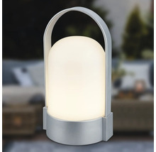 Bärbar LED-bordslampa med silverfärgad fot och bygelhandtag, kupolformad skärm, varmvitt ljus.