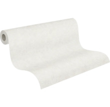 Delvis utrullad vit non-woven tapet med en diskret ytstruktur.