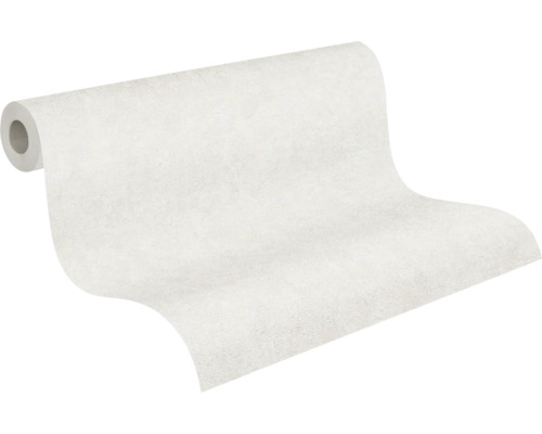 Delvis utrullad vit non-woven tapet med en diskret ytstruktur.