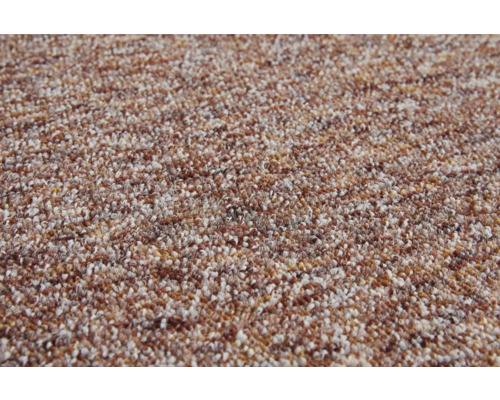 Texturerad mattas yta med melange-mönster i brunt och beige.