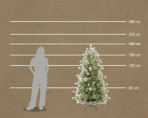 Konstgjord julgran med belysning och snöeffekt, höjd 180 centimeter, storleksjämförelse med en person.