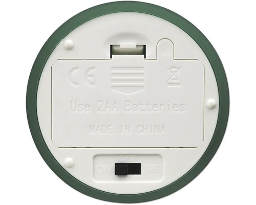 Undersida av enhet med batterifack för två AA-batterier, strömbrytare med funktionerna på, av, timer och CE-märkning.