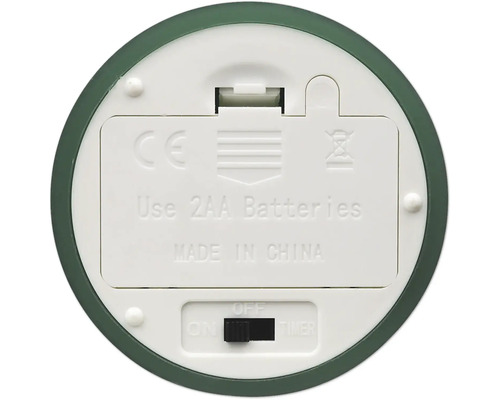 Undersidan av en apparat med batterifack för två AA-batterier, skjutreglage för på, av och timer samt CE-märkning.