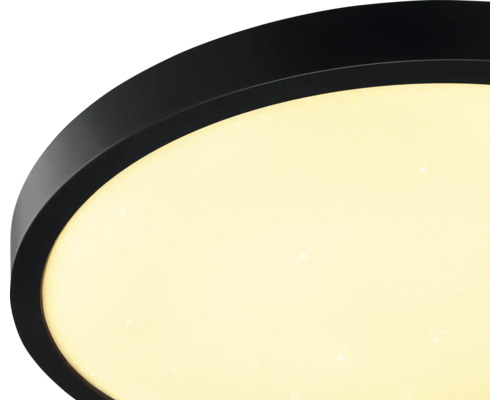 Rund LED-taklampa med svart ram och diffuser med stjärneffekt.