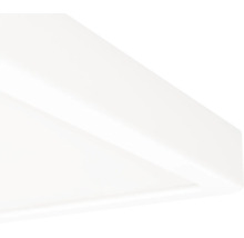 Detaljbild av hörnet på en vit taklampa eller en LED-panel.
