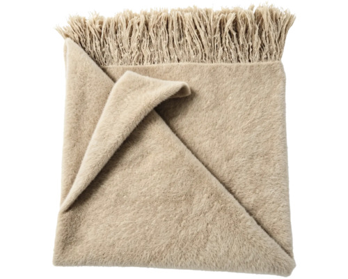 Mjuk pläd med fransar i beige.