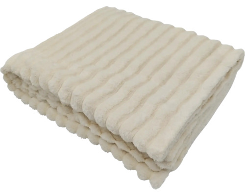 En mjuk pläd med randig struktur, hopvikt som dekorativ hemtextil.