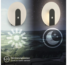 Rund LED vägglampa med skymningssensor i en dag och natt vy