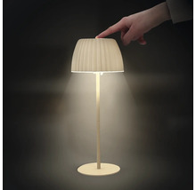 En modern LED bordslampa med plisserad skärm som slås på och av genom beröring på ovansidan.