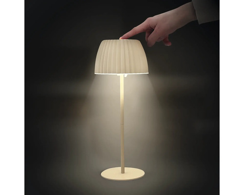 En modern LED bordslampa med plisserad skärm som slås på och av genom beröring på ovansidan.