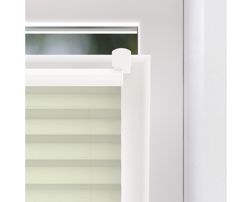 Detaljvy av en plisségardin på ett fönster