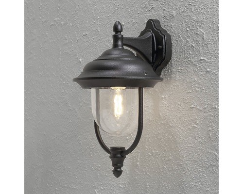 Svart utomhusvägglampa med glaskupol och retroglödlampa.