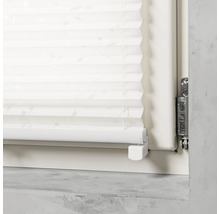 Detaljvy av en plisségardin på fönstret