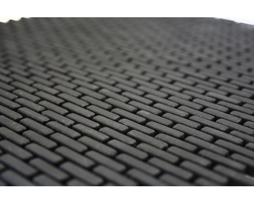 Detaljvy av en dörrmatta med tegelmönster