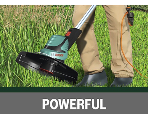 Grästrimmer i bruk på gräsmatta