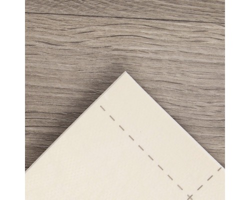 Detalj av en vit vinylplatta med prickade linjer på ett trägolv