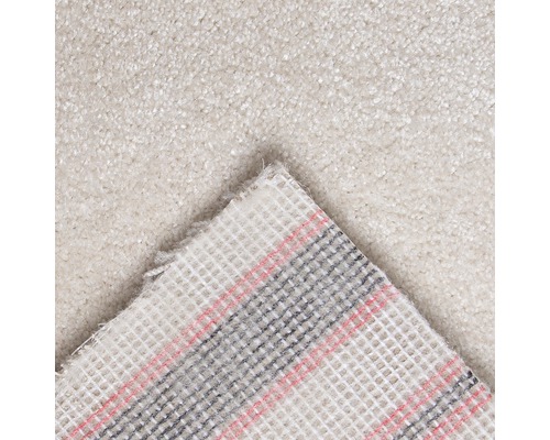 Närbild av en ljusfärgad matta med textilbaksida