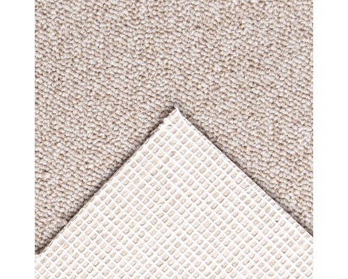 Detaljvy av en beige matta med halkfri baksida.