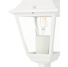 Detaljbild av en vit utomhuslampa med klart glas och glödlampa
