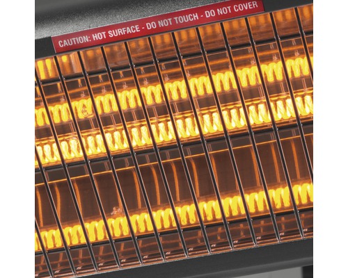 Närbild av en påslagen infravärmare med varningen: Het yta – Rör inte – Täck inte över.