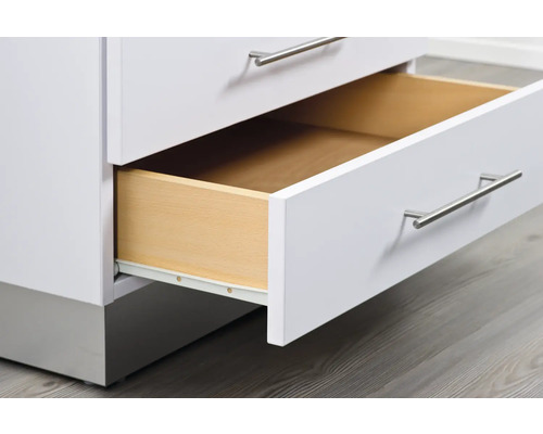 Detaljbild av ett vitt lådelement med utdragslåda