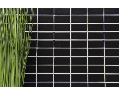 Rektangulära, glänsande mosaikplattor på en vägg med dekoration