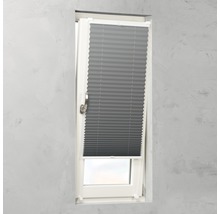 Grå plisségardin på ett fönster för ljusreglering.