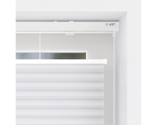 Detaljvy av en vit plisségardin vid fönstret