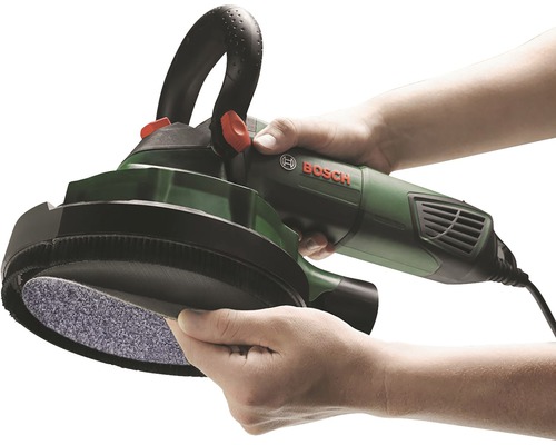Man håller en betongslipmaskin från Bosch.