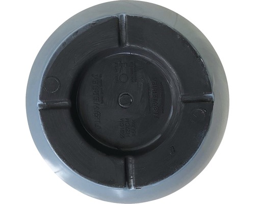 Undersida av en blomkruka med borrmarkering